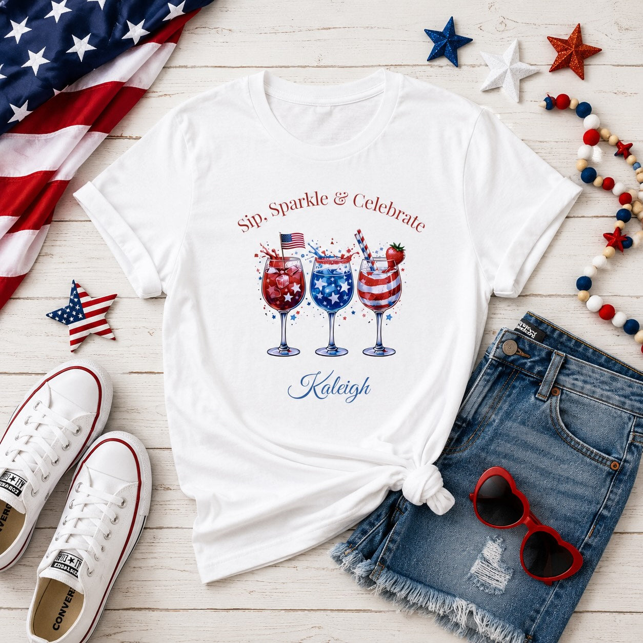 Sip Sparkle & Celebrate organic cotton tee lifestyle mockup – semi-slim fit 4th of July shirt with red white blue cocktail glasses